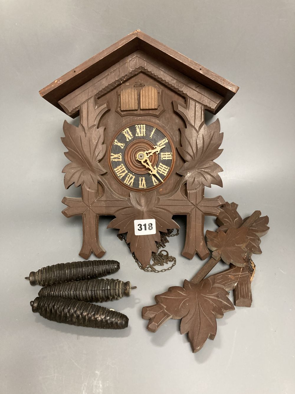 A Black Forest carved cedar cuckoo clock